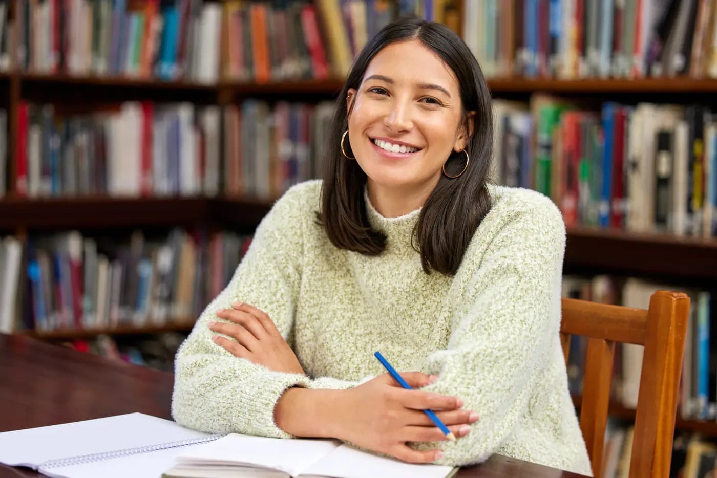 Author surrounded by books in a library