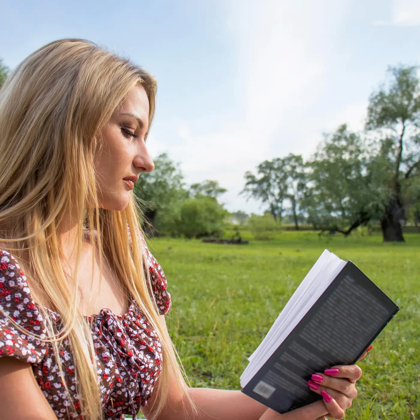 A reader enjoying a book outdoors